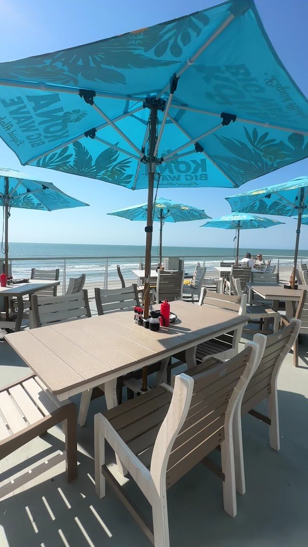 Patio tables with ocean light beyond.